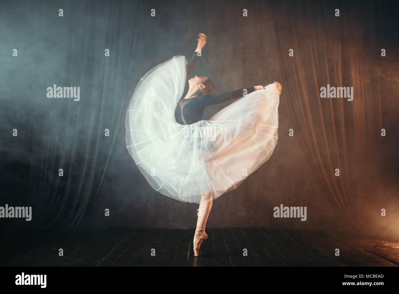 Ballet dancer in motion on the stage in theatre Stock Photo