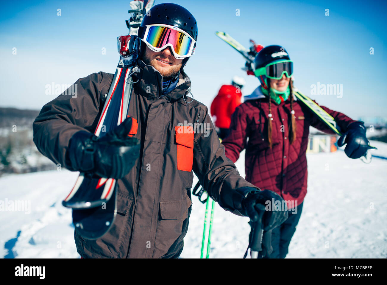 Male and female skiers poses with skis and poles Stock Photo