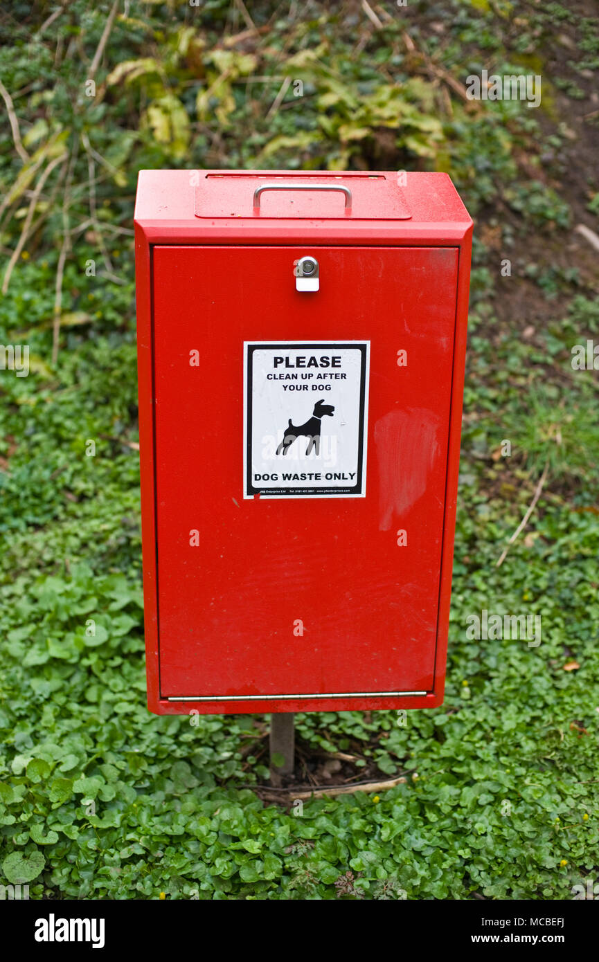 Red dog poo bin on the Old Railway Footpath Hay-on-Wye Powys Wales UK Stock Photo