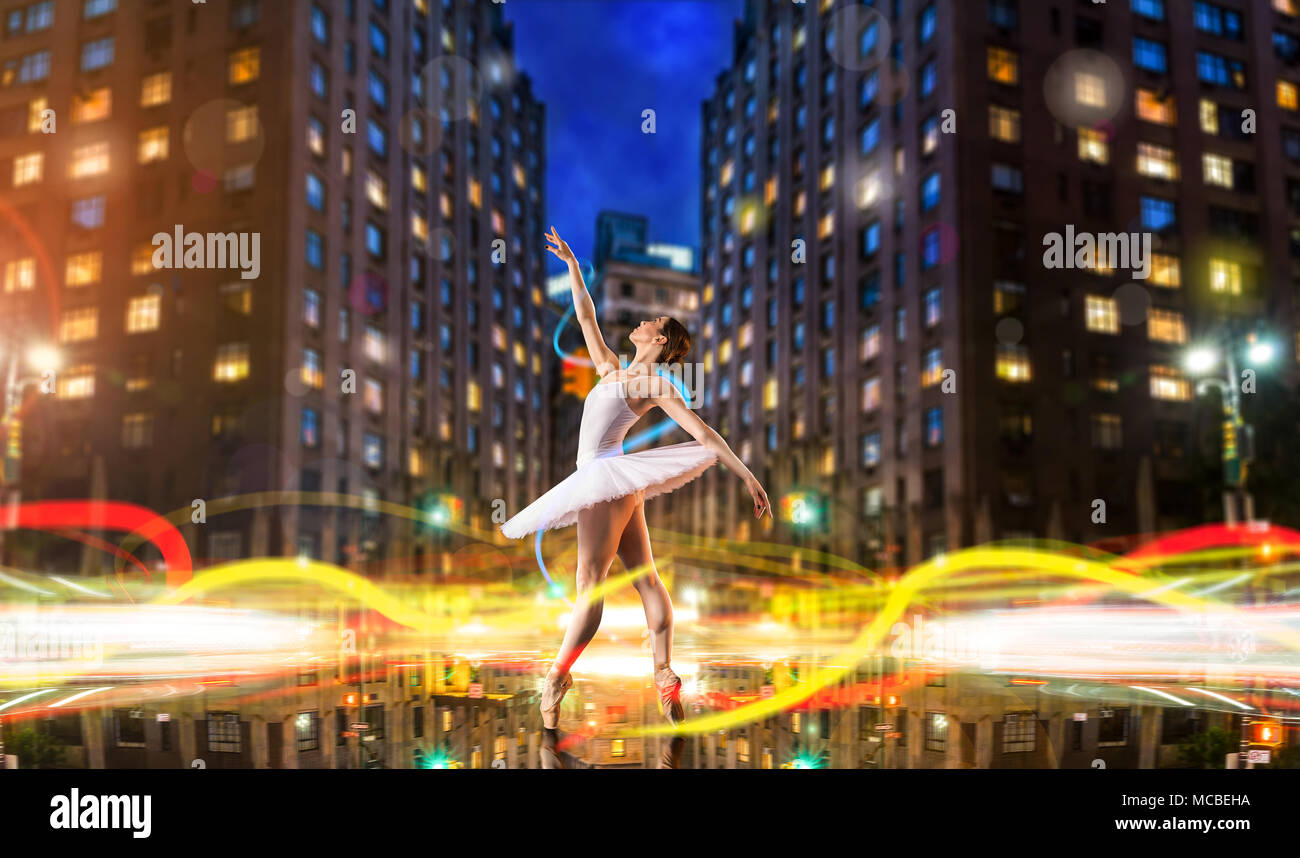 Classical ballet dancer dancing on city road Stock Photo