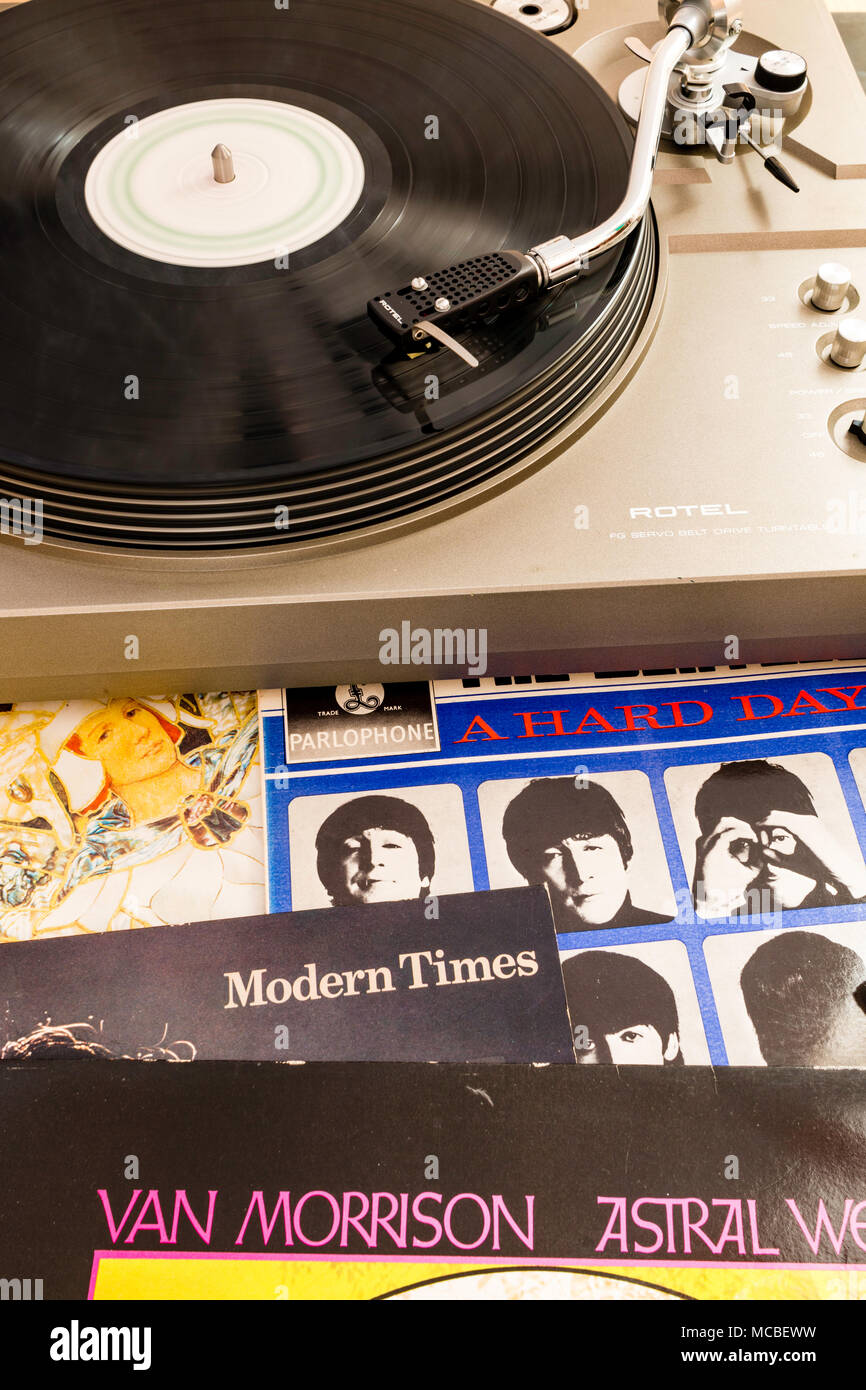 Looking down on Record player deck with S type arm, playing record with other LP record covers scattered around. Beatles, A Hard days Night. Stock Photo