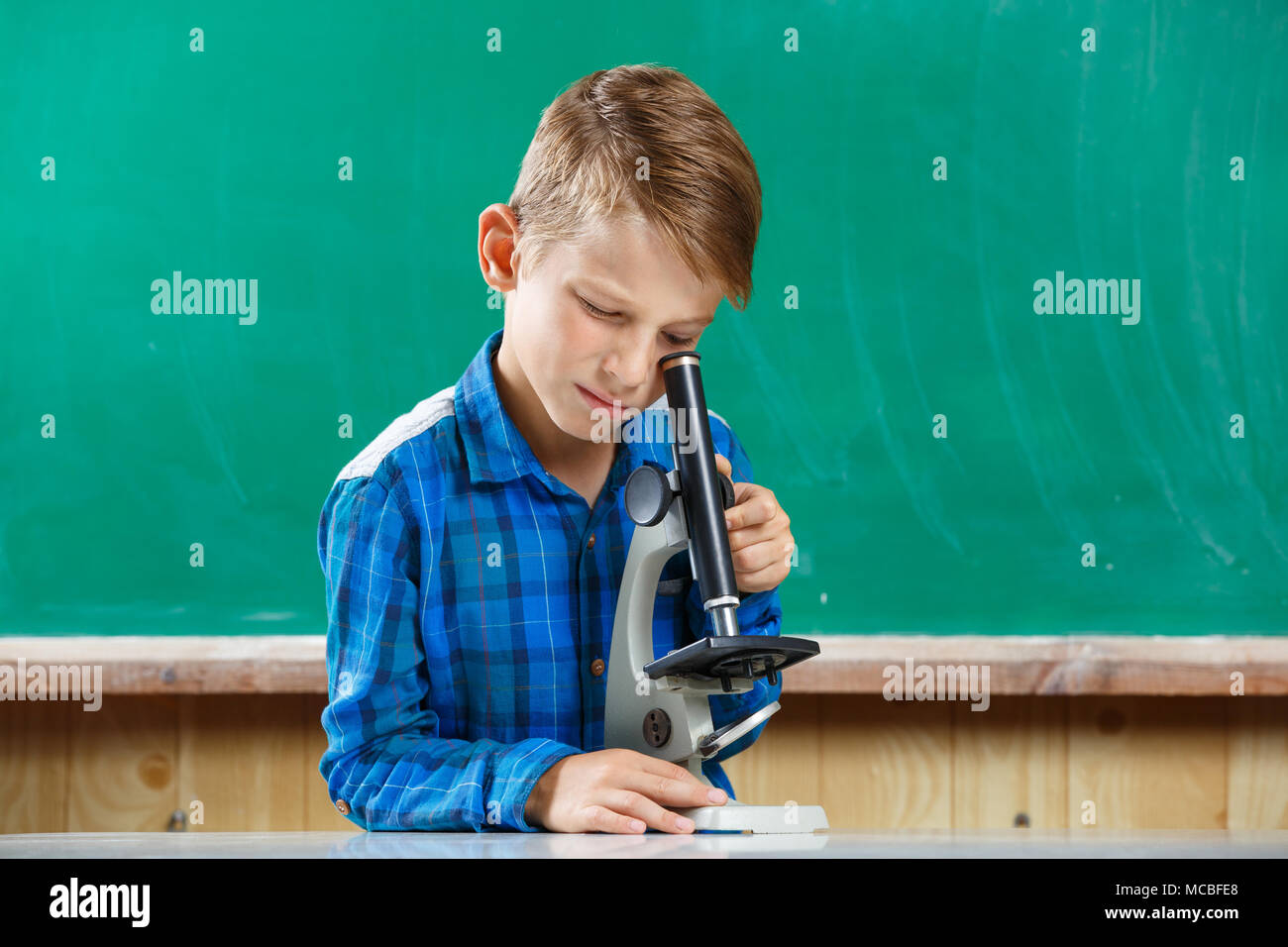 Elementary school student using microscope on lesson Stock Photo Alamy