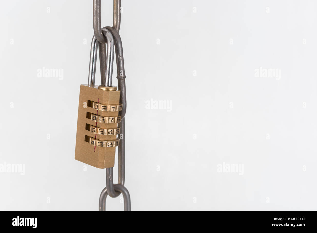 Macro-photo of small combination padlock with metal chain links. Metaphor for Blochain / Bitcoin blockchain. China Bitcoin conference metaphor. Stock Photo