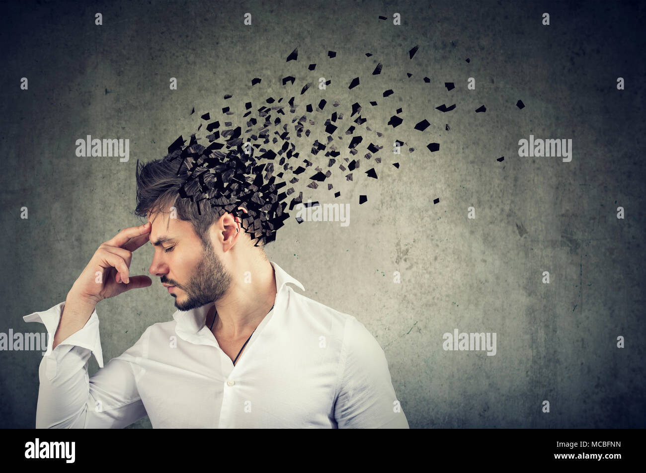 Memory loss due to dementia or brain damage. Side profile of a man losing parts of head as symbol of decreased mind function. Stock Photo