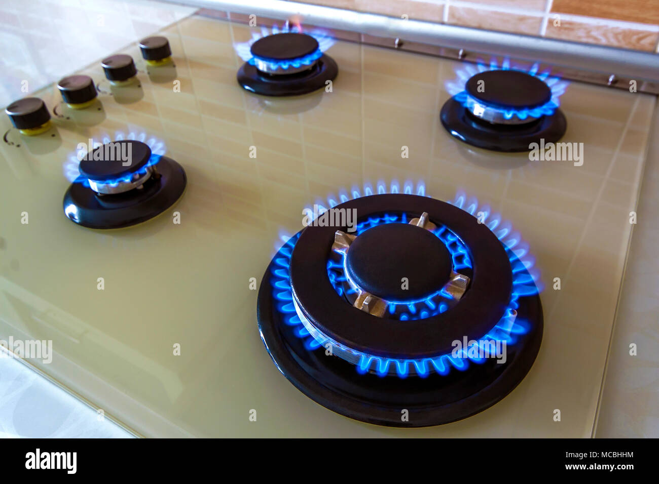 Closeup shot of blue fire from domestic kitchen stove. Gas cooker with