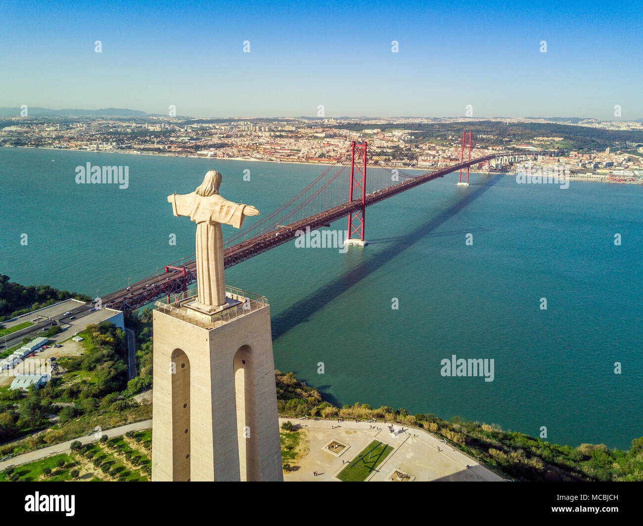 Jesus Christ monument by Tagus river with bridge Ponte 25 de Abril, Lisbon,  Portugal Stock Photo - Alamy
