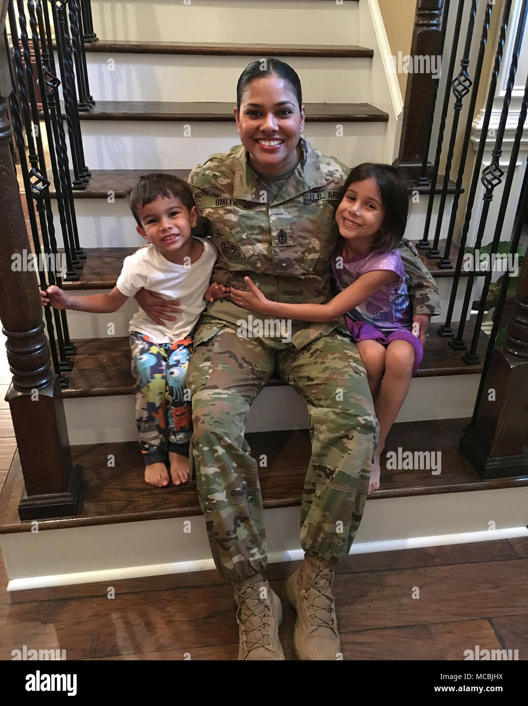 U.S. Army Reserve 1st Sgt. Lorraine Smith, first sergeant for Headquarters and Headquarters Company, 98th Training Division (Initial Entry Training), with her 4-year-old son, Cooper, and her 6-year-old daughter, Isabella. Stock Photo