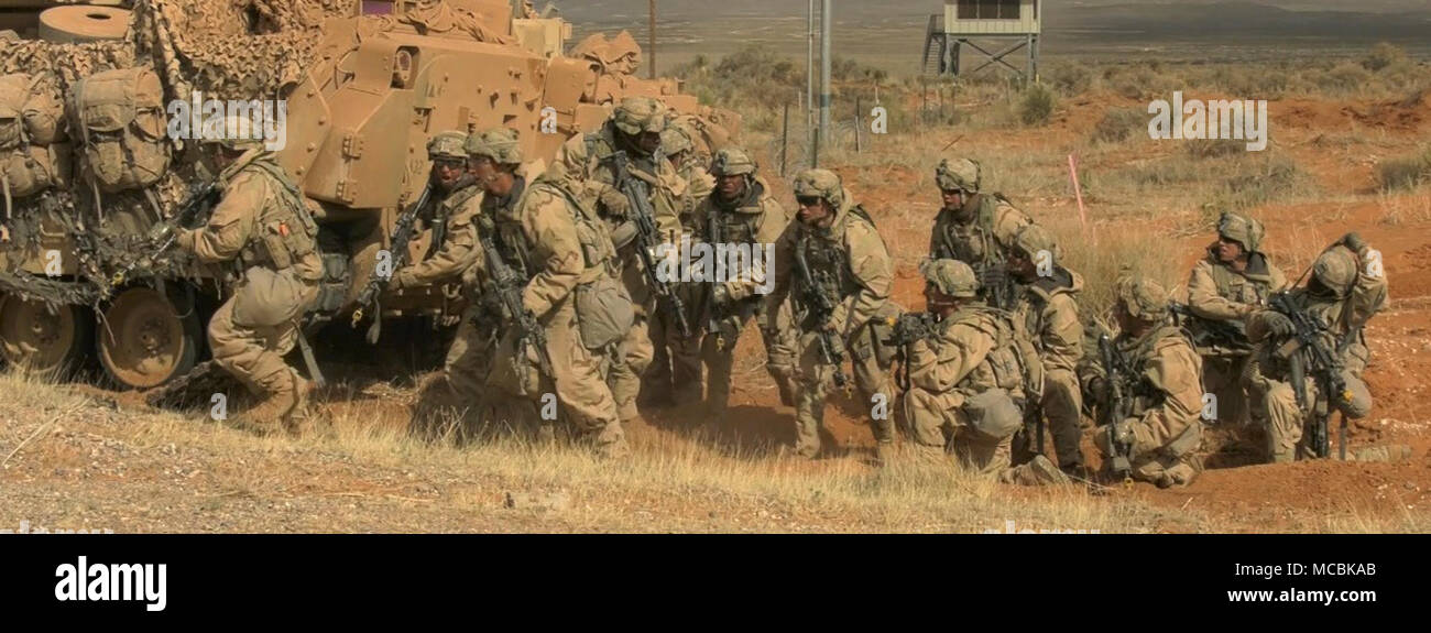 Infantrymen with 3rd Battalion, 41st Infantry Regiment, 1st Stryker Brigade Combat Team, 1st Armored Division advance towards their objective after dismounting Bradley Fighting Vehicles at the Combined Arms Collective Training Facility, Orogrande, N.M., March 22, 2018. The training conducted was part of Iron Focus 18.1, a brigade exercise designed to prepare 3rd Armored Brigade Combat Team, 1st Armored Division, for a National Training Center rotation. Stock Photo