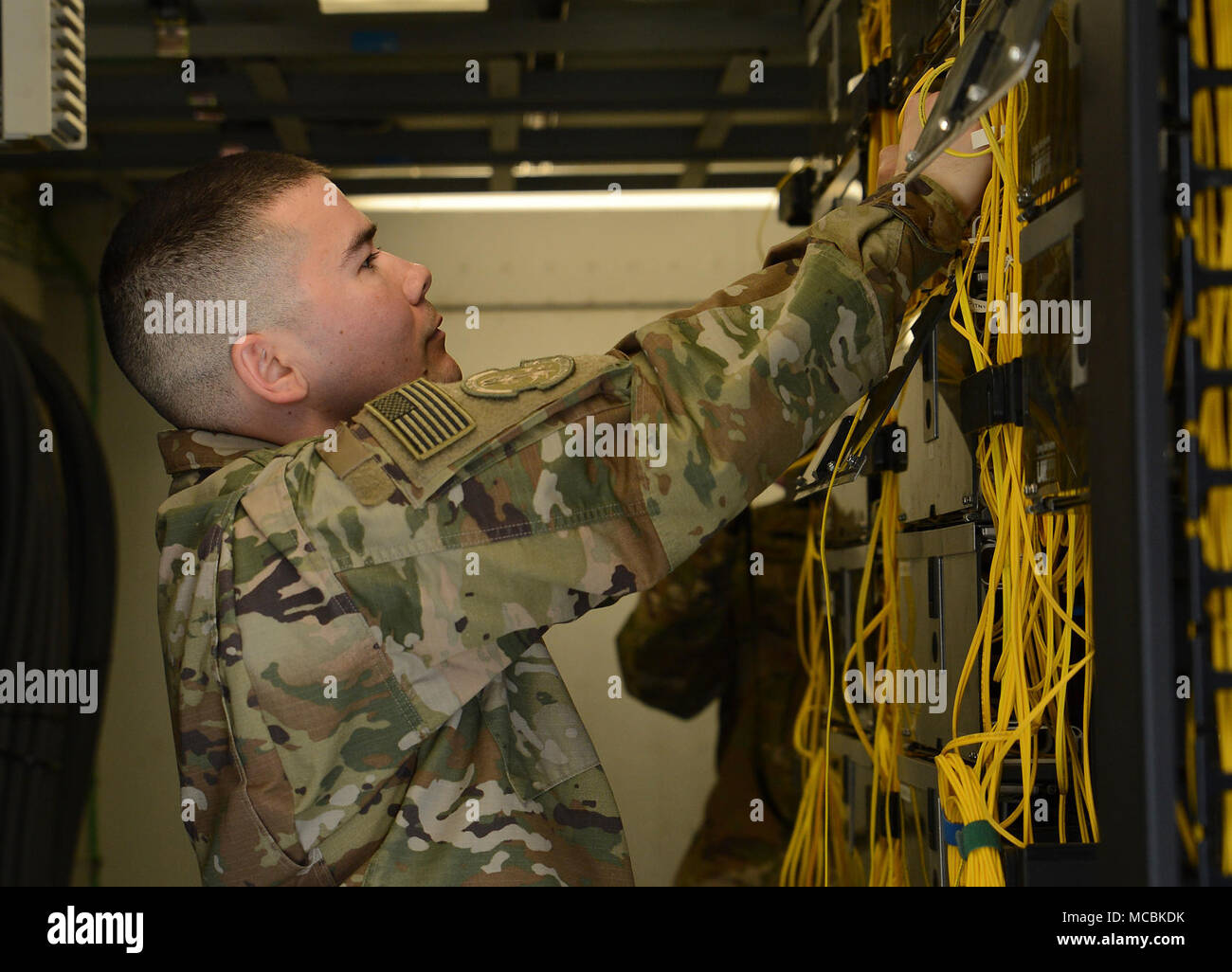 Staff Sgt. Brandon Hasegawa, 455th Expeditionary Communication Squadron cyber transport technician, checks the non-secure internet protocol router wires Mar. 22, 2018 at Bagram Airfield, Afghanistan. Hasegawa is charged with maintaining and managing the base’s non-secure internet protocol router, secret internet protocol router and the Comprehensive Airman Fitness network. Stock Photo