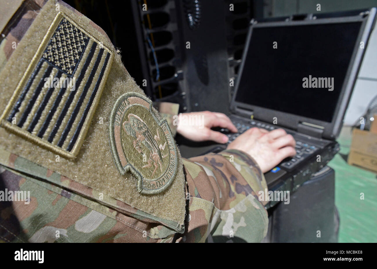 Staff Sgt. Brandon Hasegawa, 455th Expeditionary Communication Squadron cyber transport technician, activates a network port Mar. 22, 2018 at Bagram Airfield, Afghanistan. In addition to maintaining and managing the network, Hasegawa stays busy dealing with vulnerability issue, testing and troubleshooting network systems equipment as well as port activations. Stock Photo