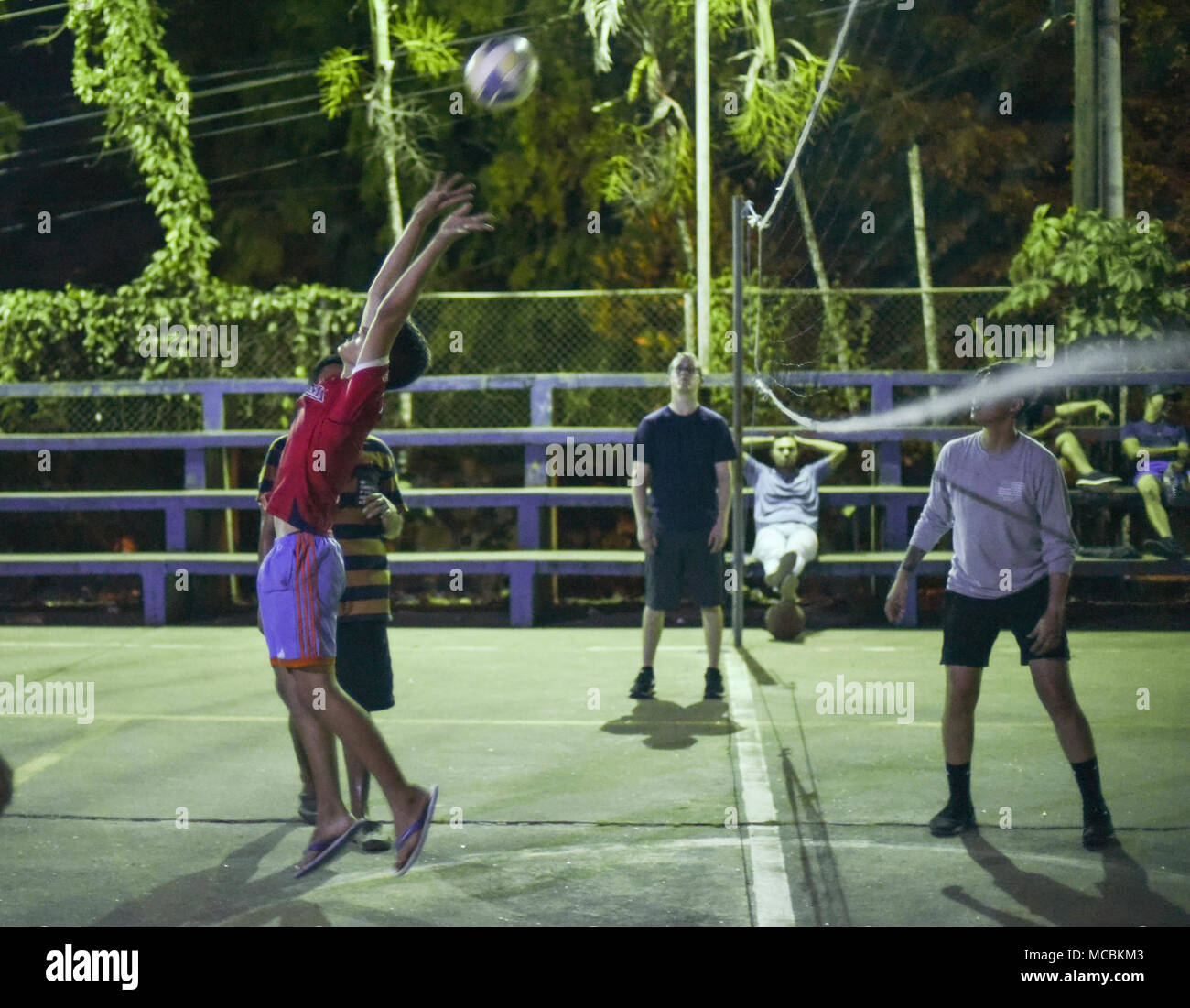 A Meteti, Panama, local citizen hits a ball during a volleyball match with U.S. military members participating in Exercise New Horizons 2018, March 27, 2018. Throughout the duration of the exercise, participants spend time engaging in sports and fun activities within the local community Exercise New Horizons is a joint training exercise where all branches of the U.S. military conduct training in civil engineer, medical and support services while benefiting the local community. Stock Photo