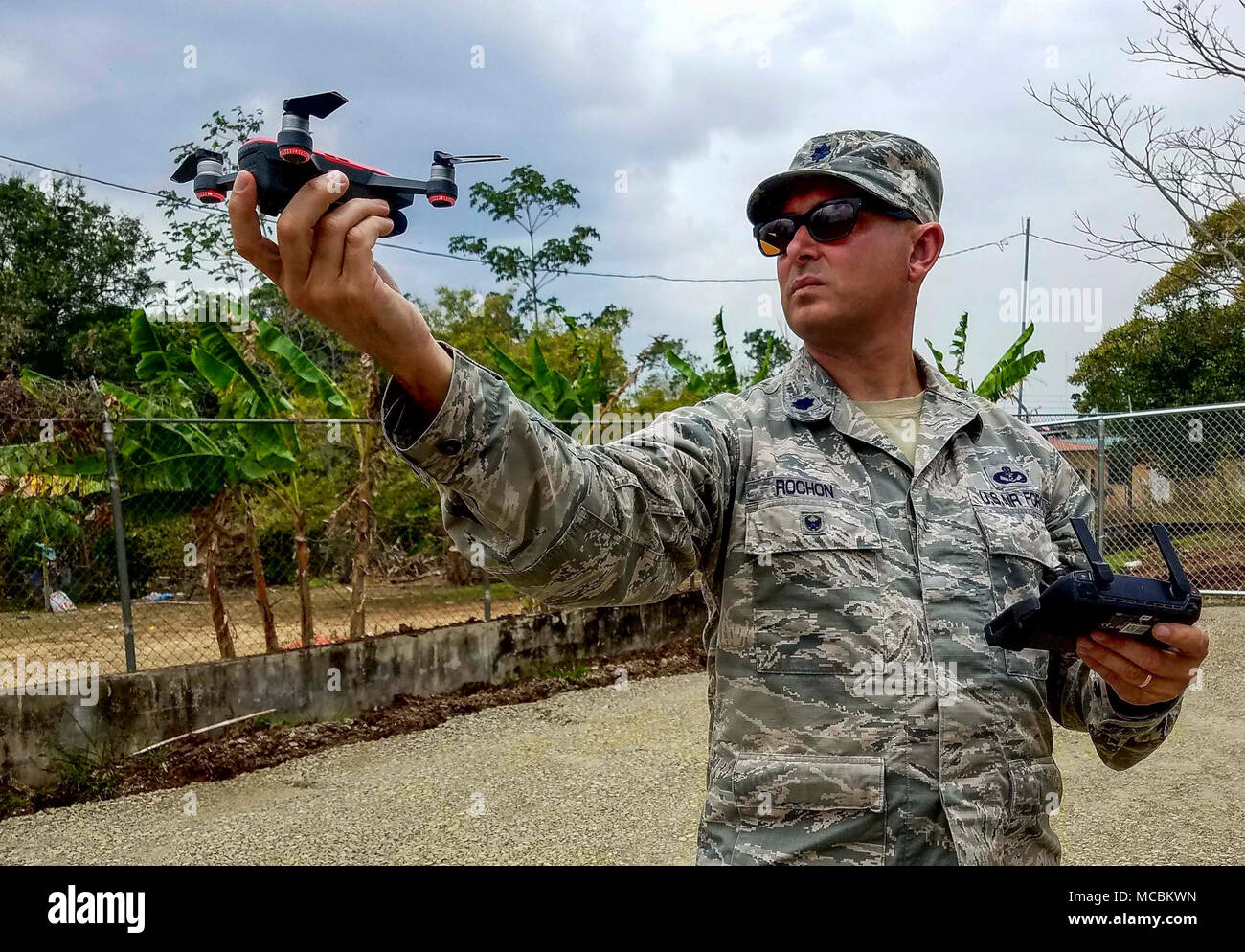 U.S. Air Force Lt. Col. Matthew Rochon, 346th Air Expeditionary Group deputy commander, prepares to operate a small drone to photograph work sites in Meteti, Panama, March 30, 2018. As construction projects continue, photographs will help document the work being done. Exercise New Horizons is a joint training exercise where all branches of the U.S. military conduct training in civil engineer, medical and support services while benefiting the local community. Stock Photo