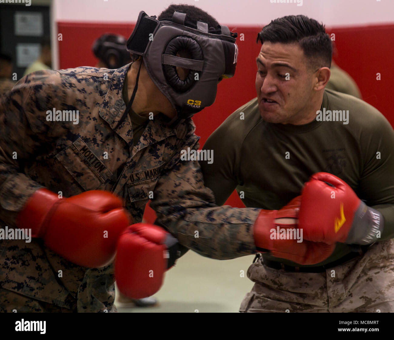 Lance Cpl. Vincent A. Morton spars with martial arts instructor, Sgt. Skylar Voegele, during a black belt course on Camp Foster, Okinawa, Japan, March 23, 2018. Marine Corps Martial Arts Program is an integrated, weapon-based system that incorporates the full spectrum of the force continuum on the battlefield, and contributes to the mental, character and physical development of Marines. Voegele is a martial arts instructor with 1st Marine Aircraft Wing. Morton is a tax clerk with Headquarters and Support Battalion, Marine Corps Installations Pacific. Stock Photo