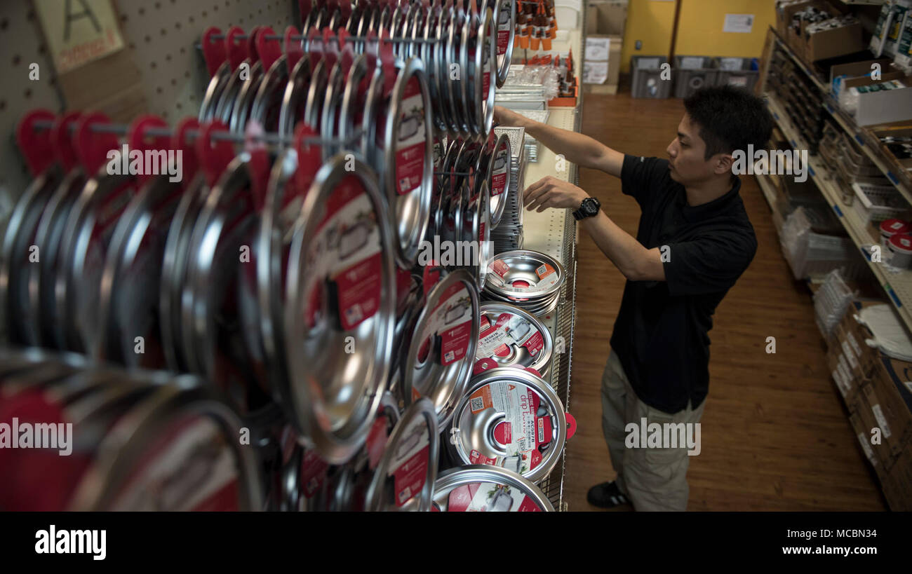 Seiji Ikehara, Eagle Hardware Store inventory specialist, stocks merchandise at the Eagle Hardware Housing Self-Help Store Mar. 26, 2018 on Kadena Air Base, Japan. The self-help store offers drip pans for stoves, horizontal blinds and lightbulbs for a one for one swap to help housing residents with general upkeep. Stock Photo