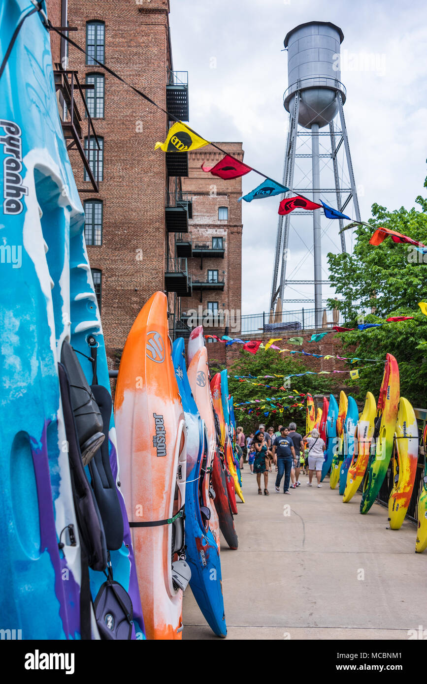 Colorful kayaks line the walkway from the Columbus RiverWalk to Paddle