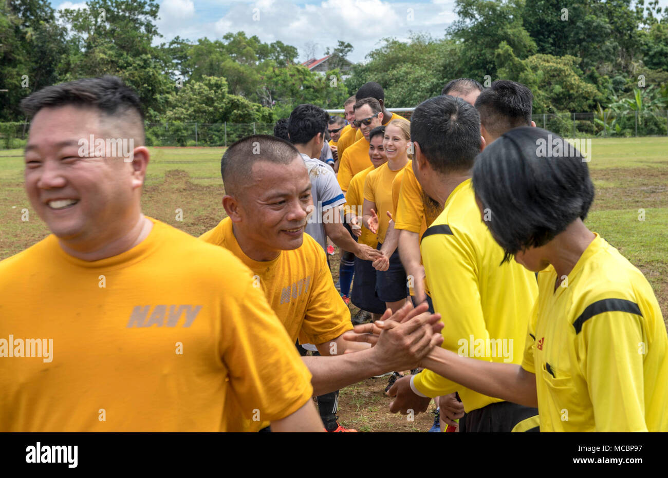 Indonesia (March 30, 2018) Sailors assigned to Military Sealift Command hospital ship USNS Mercy (T-AH 19) and students who attend the University of Bengkulu shake hands after a soccer game during a community relations event at the University of Bengkulu soccer field. Mercy is currently deployed in support of Pacific Partnership 2018 (PP18). PP18’s mission is to work collectively with host and partner nations to enhance regional interoperability and disaster response capabilities, increase stability and security in the region, and foster new and enduring friendships across the Indo-Pacific Reg Stock Photo