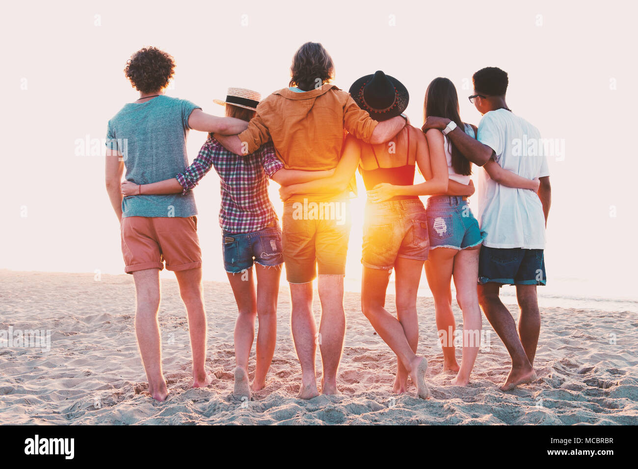 Group of happy friends having fun at ocean beach Stock Photo