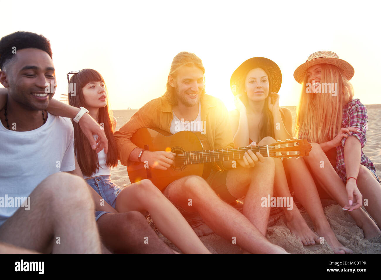 Happy group of friend having party on the beach Stock Photo