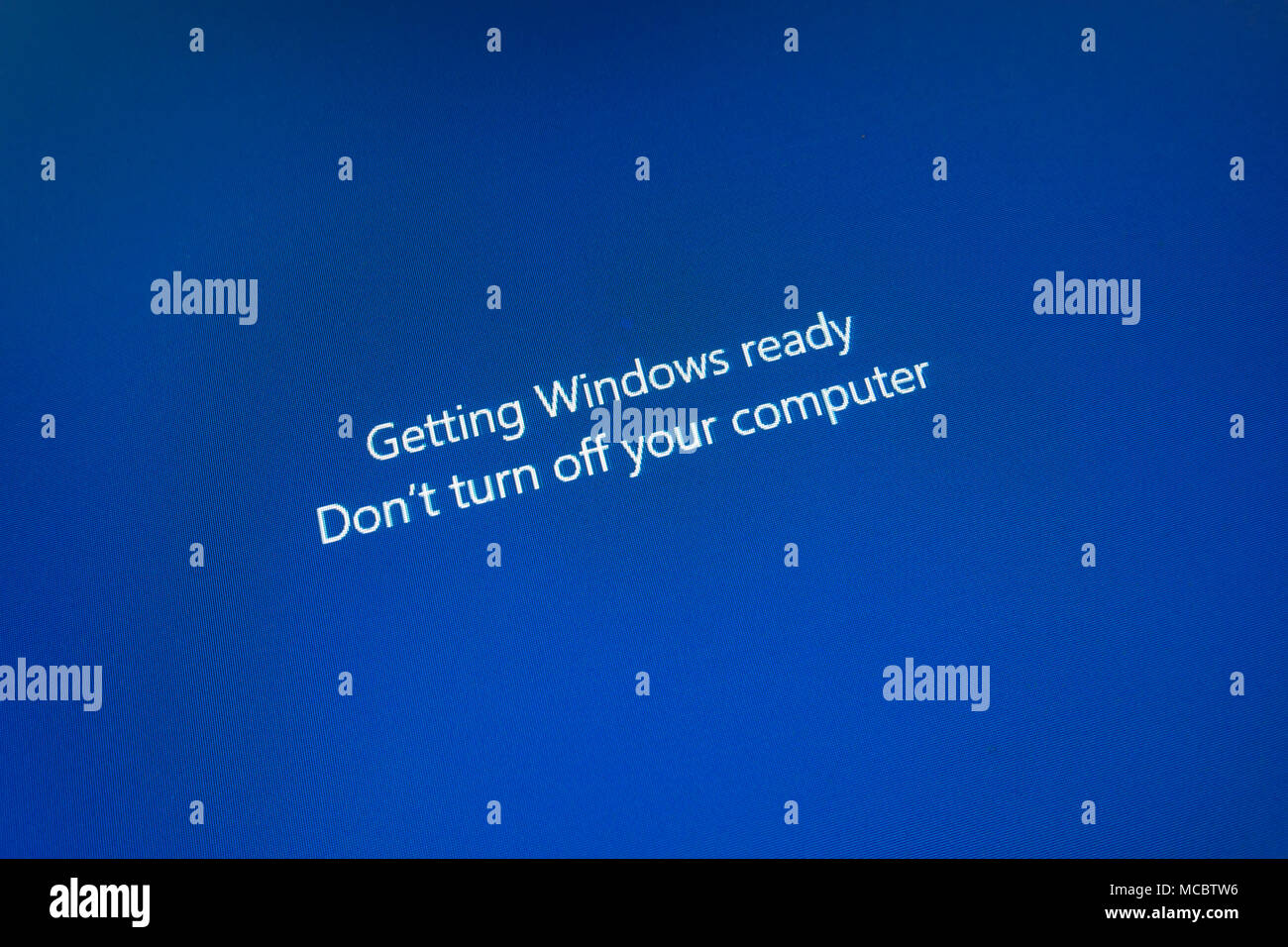 Blue computer screen showing message Getting Windows Ready Do Not turn off computer Stock Photo