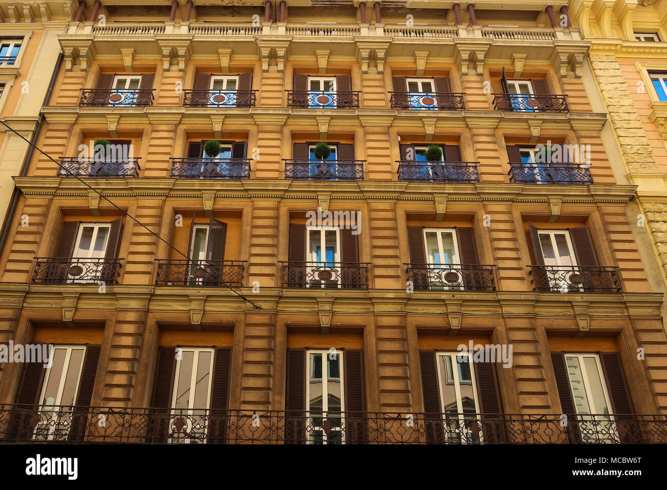 Facade of traditional colorful european italian apartment building in