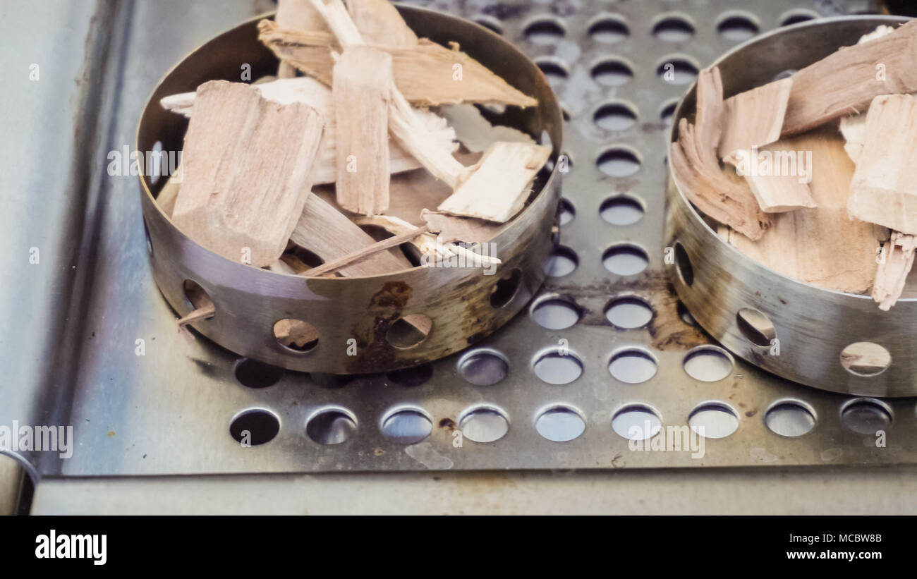 Stainless steel wood chip smoker box for gas grill Stock Photo Alamy