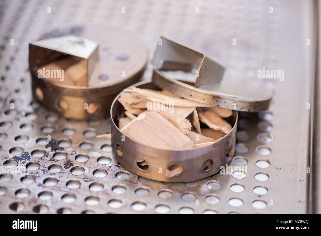 Stainless steel wood chip smoker box for gas grill Stock Photo Alamy