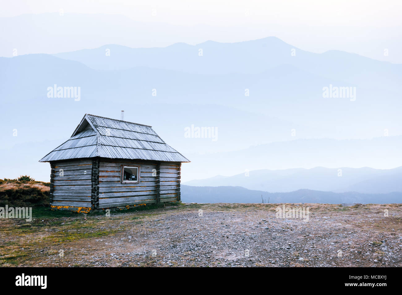 Mountain cabin during sunrise. Stock Photo