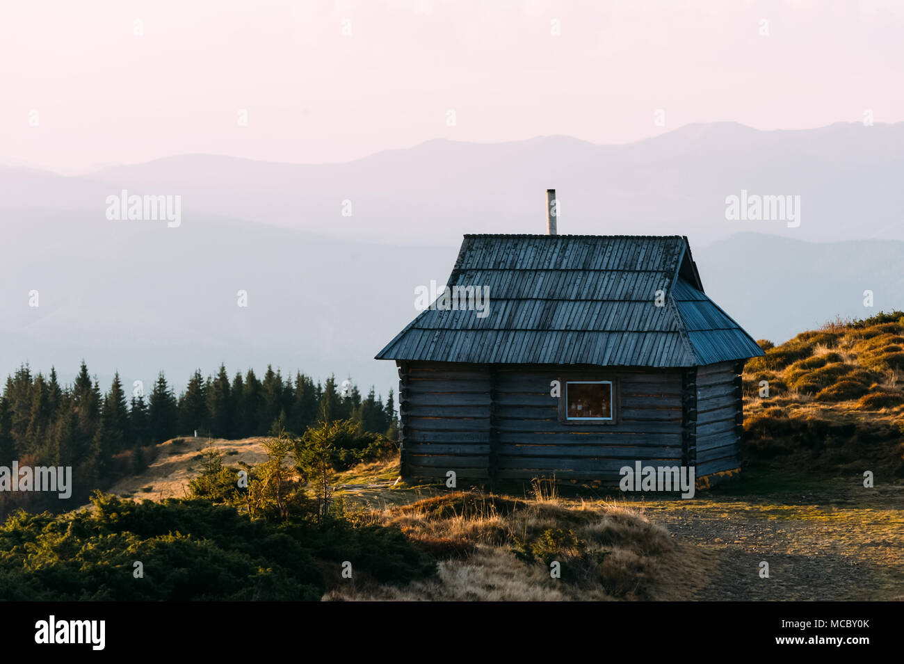 Mountain cabin during sunrise. Stock Photo
