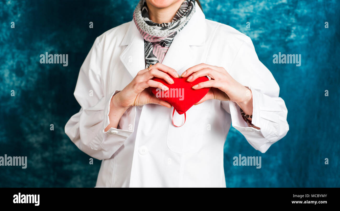 Female doctor holding a red heart close up Stock Photo - Alamy