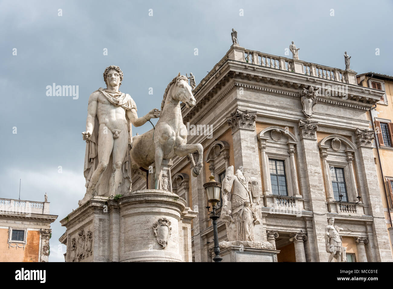 Sculpture of Pollux and horse at entrance to Piazza del Campidoglio on Capitoline Hill, Rome; looking up against cloudy sky with soft light, no people Stock Photo
