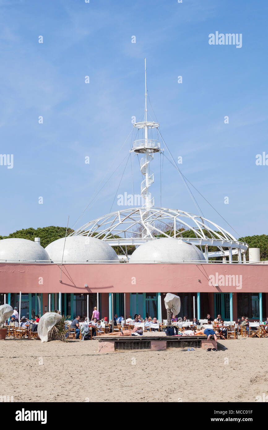 Locals sunbathing outside the restaurant and observation tower Blue Moon Beach, Lido di Venezia (Venice Lido, Lido Island)), Veneto, Italy at the star Stock Photo