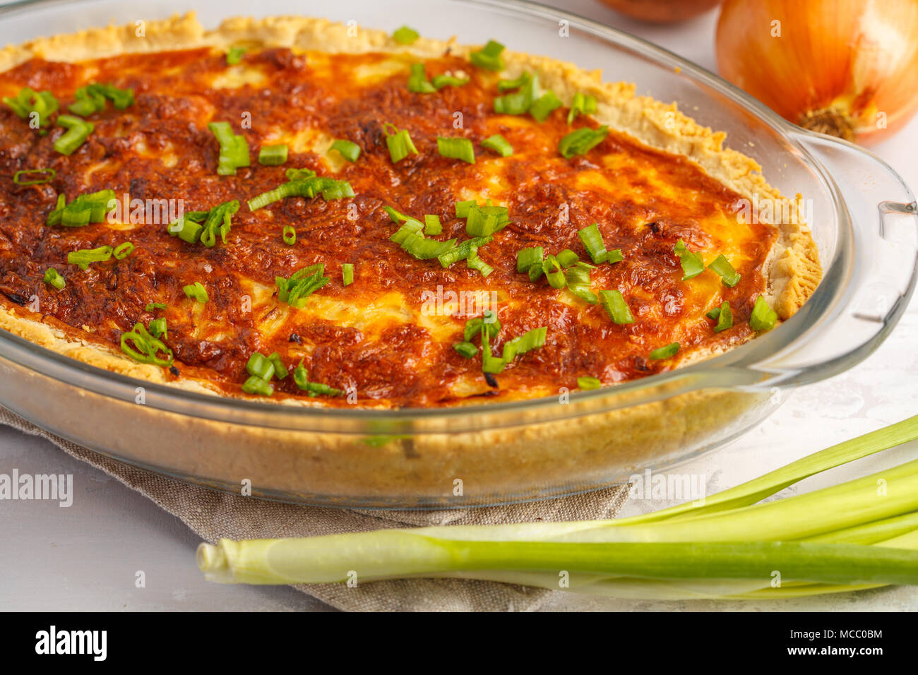 Vegetarian potato pie. Quiche lorraine with potatoes, cheese and eggs in a glass oven dish. Stock Photo