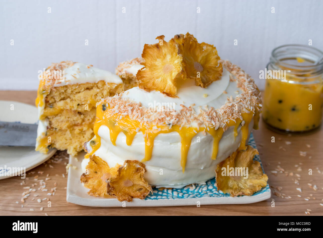 Sliced Pineapple And Coconut Layer Cake Served With Passion Fruit Sauce On Handmade Ceramic Plates Stock Photo Alamy