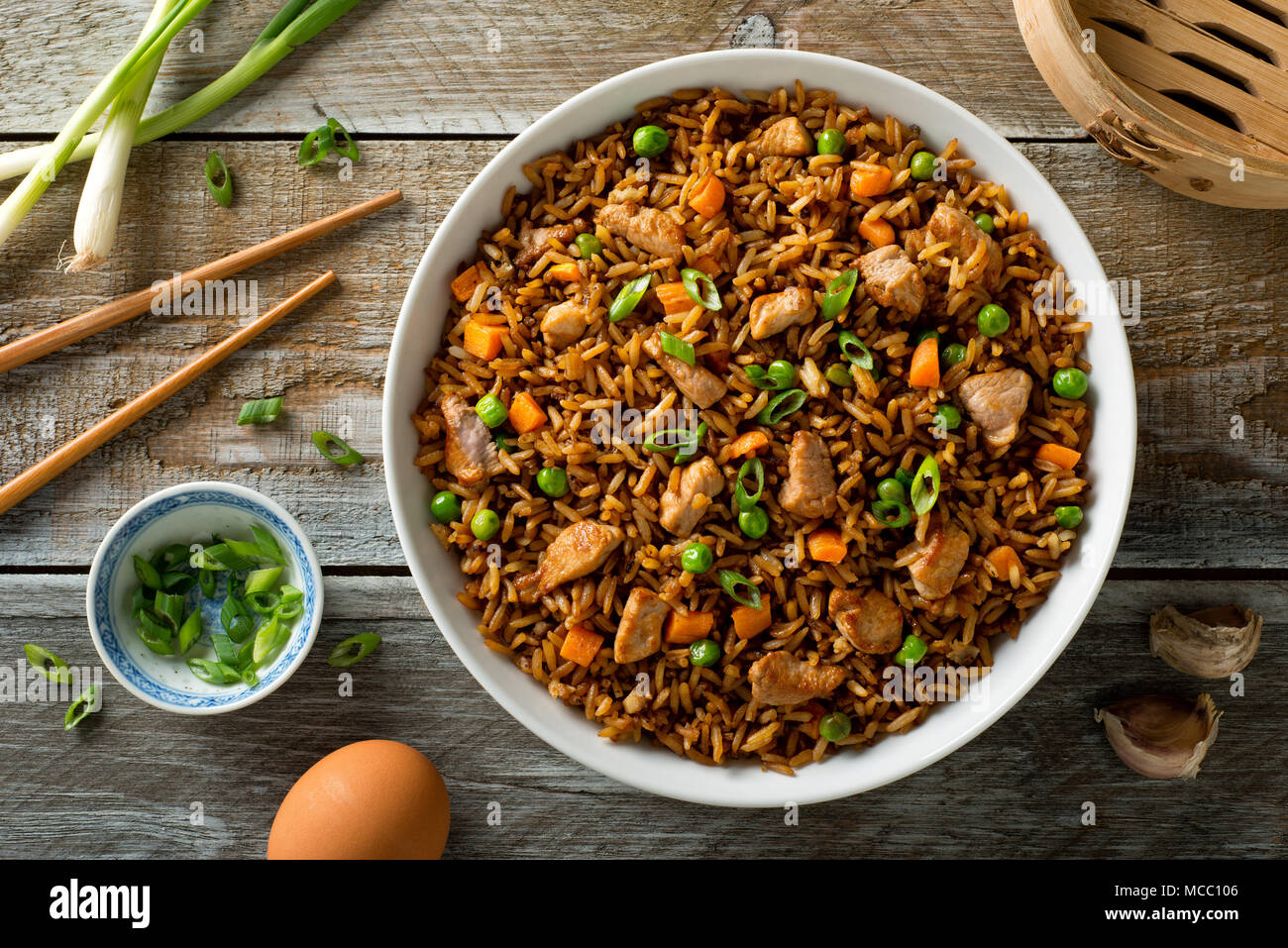 Delicious pork fried rice with egg, carrot, green peas, garlic and green onion. Stock Photo