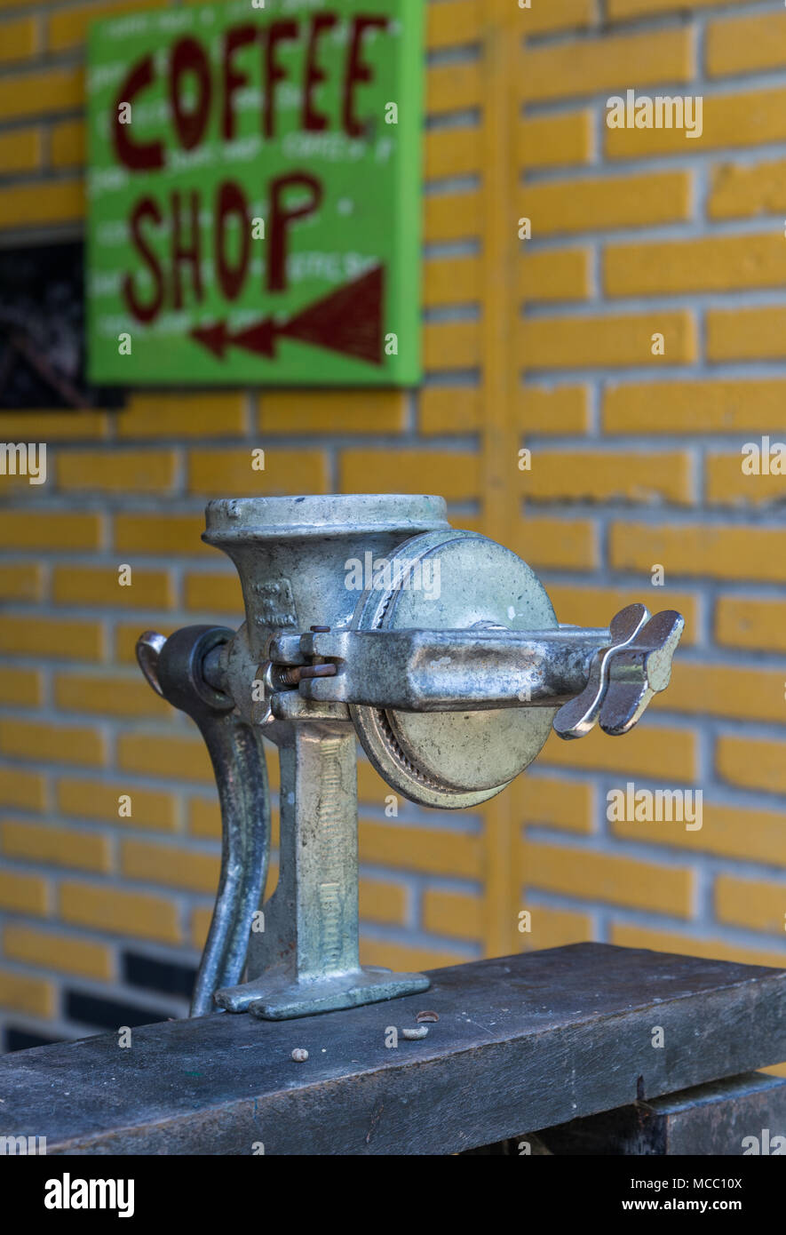 A manual coffee grinder in front of a coffee shop. Minca, Colombia, South America. Stock Photo