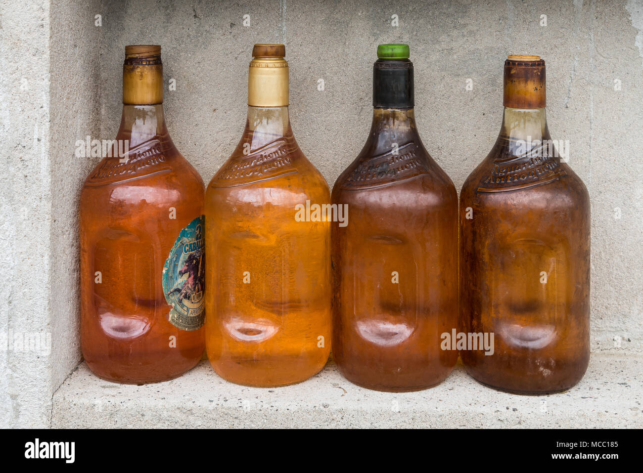 Antique glass gasoline bottles at a rural petro station. Colombia, South America. Stock Photo