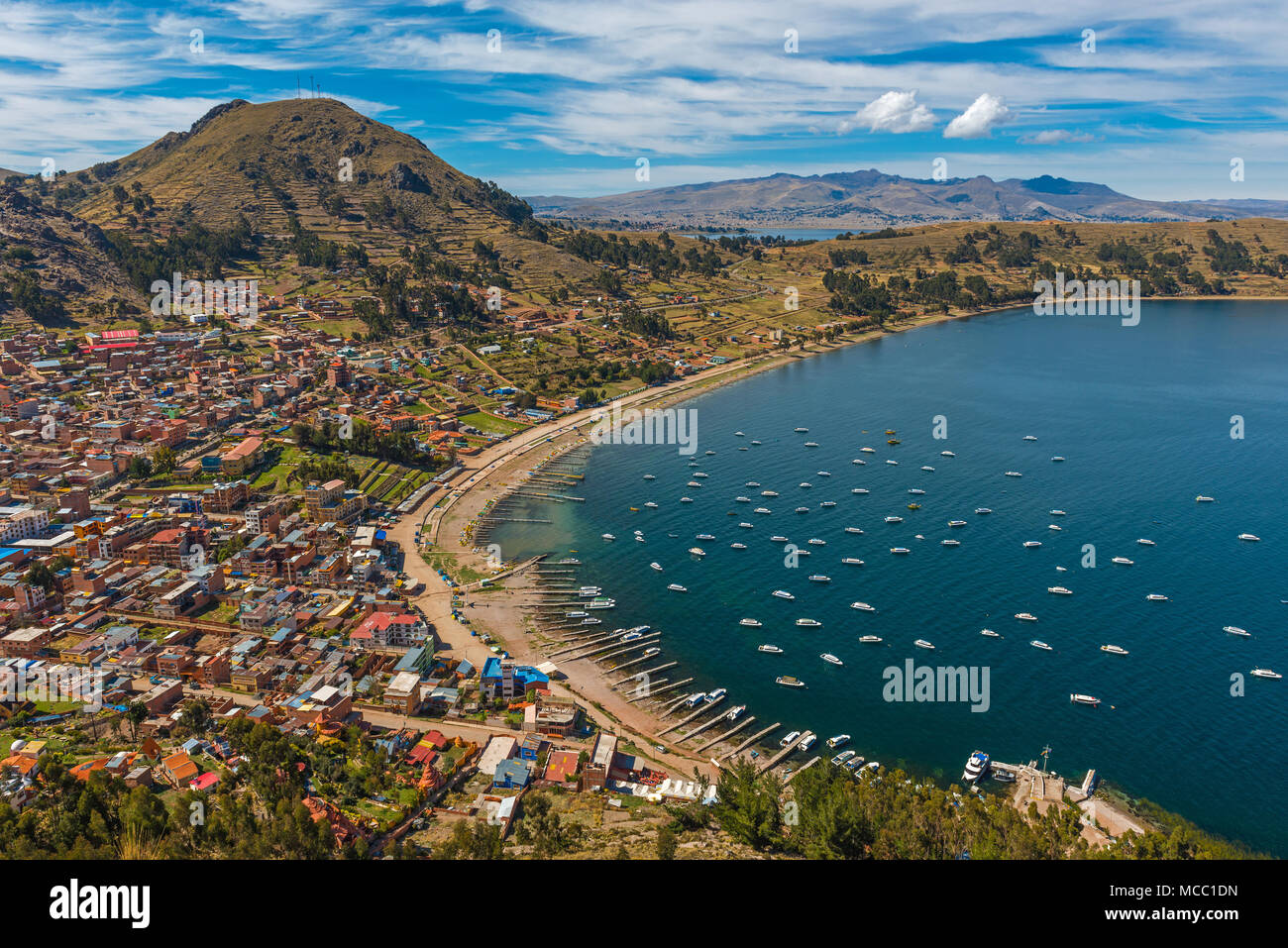 Cityscape of Copacabana city seen from the Calvary mountain in the early morning with a view over the deep blue waters of the Titicaca Lake, Bolivia. Stock Photo