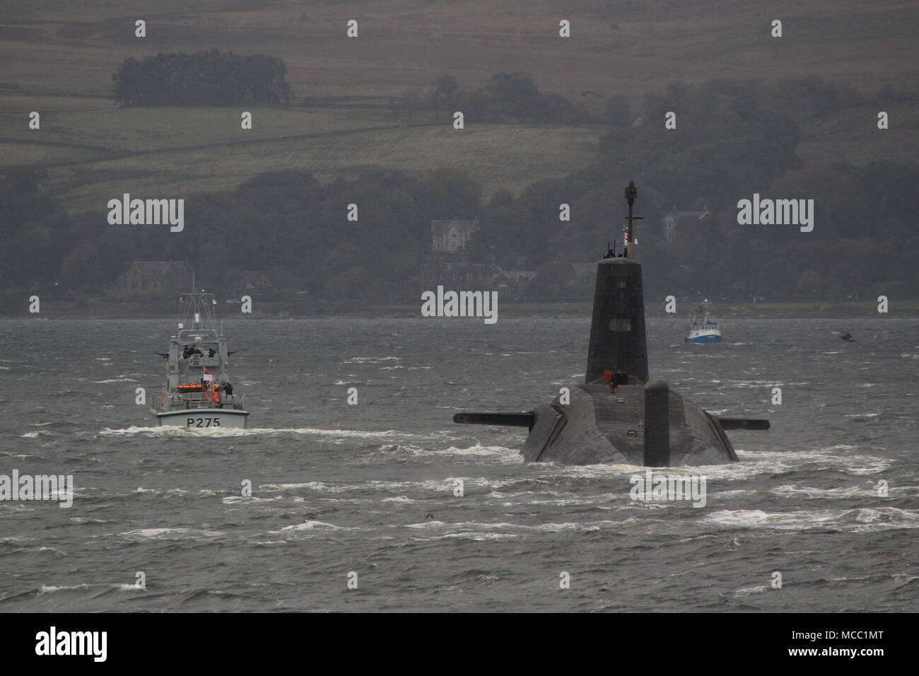 HMS Victorious (S29), a Vanguard-class submarine operated by the Royal Navy, on an inbound journey to the Faslane naval base, with HMS Raider (P275). Stock Photo