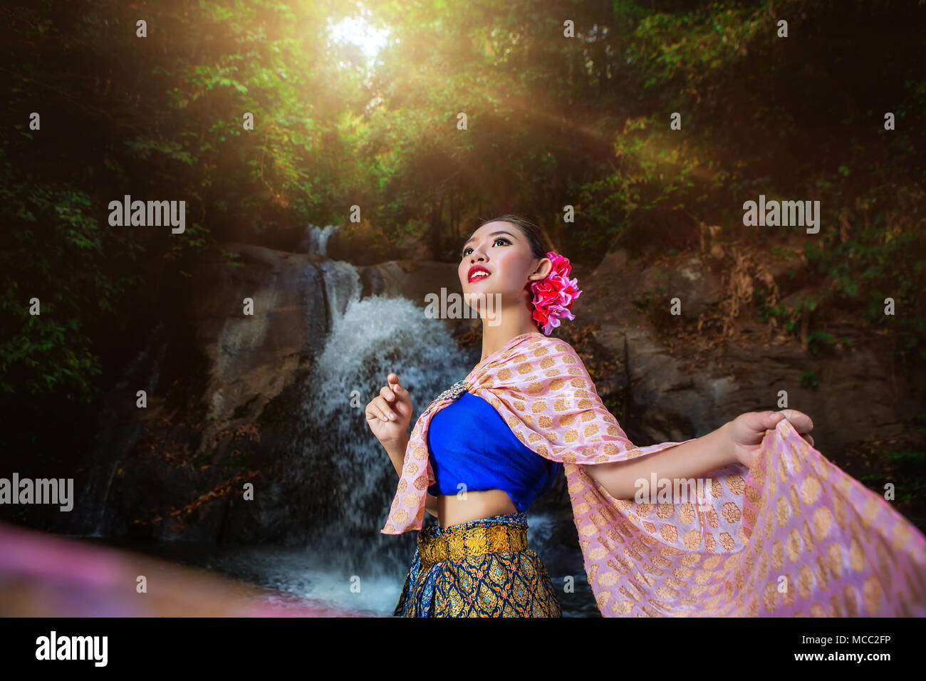 Thai girl with northern style dress in Waterfall,  identity culture of thailand. Stock Photo