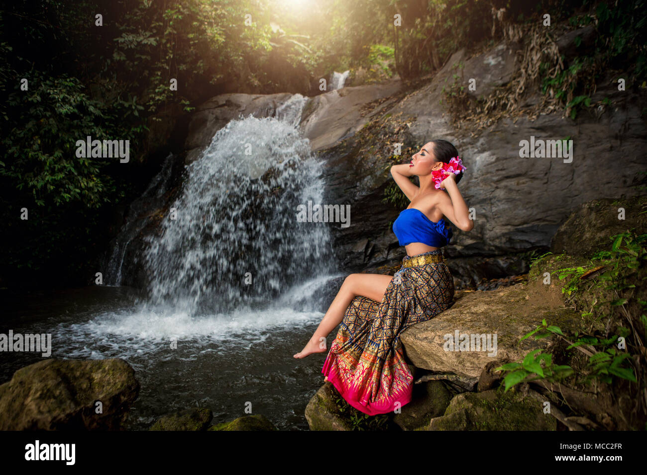 Thai girl with northern style dress in Waterfall, identity culture of thailand. Stock Photo