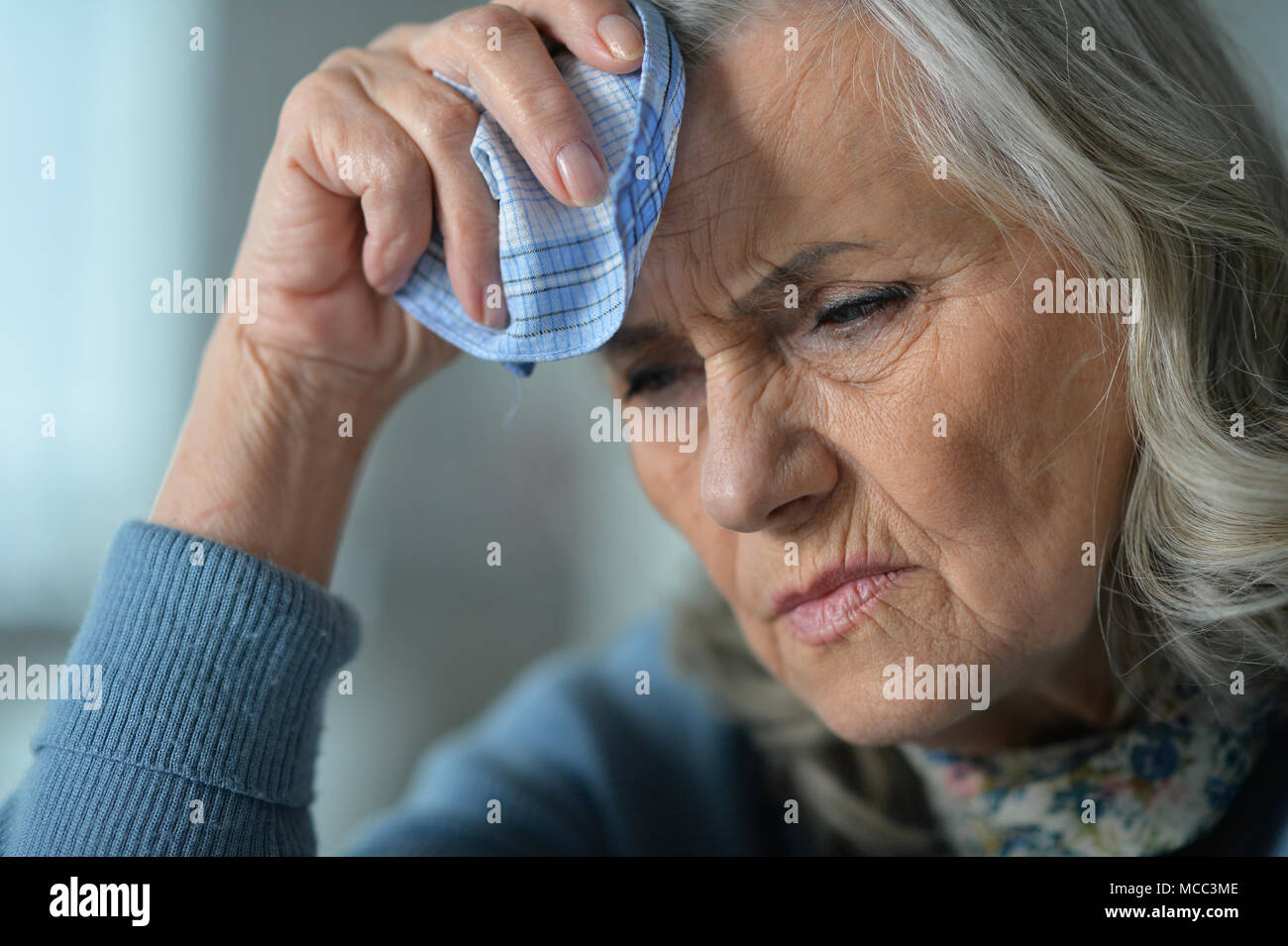 Sad woman holding handkerchief hi-res stock photography and images - Alamy