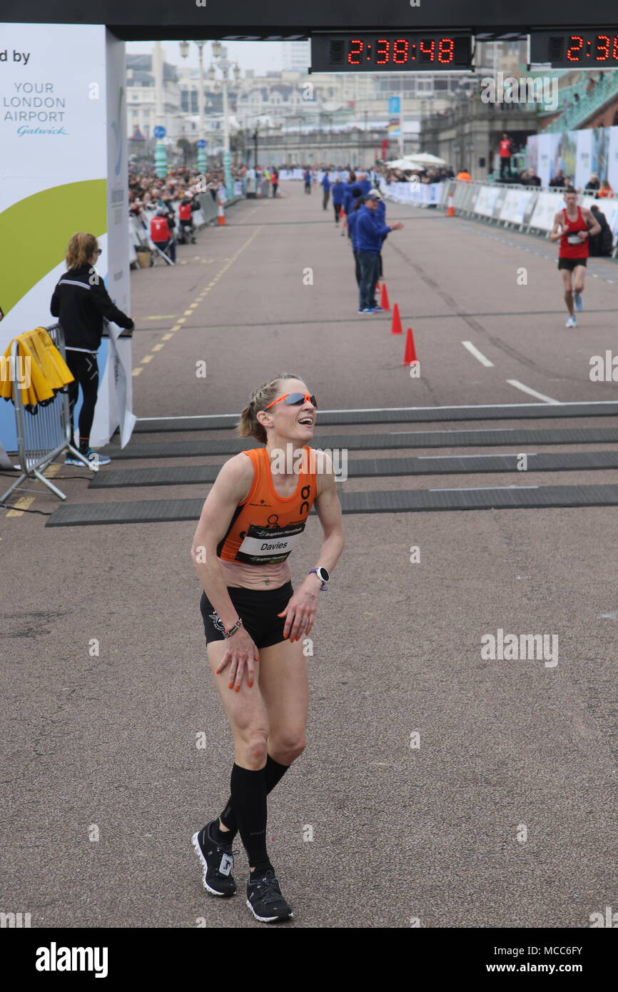 a female runner ready to collapse at the end of a marathon running race