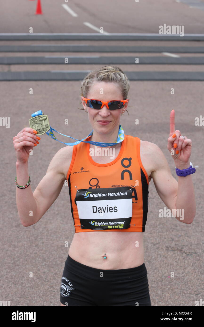 Helen Davies hold up her medal after winning the Brighton Marathon for a second consecutive year. Stock Photo
