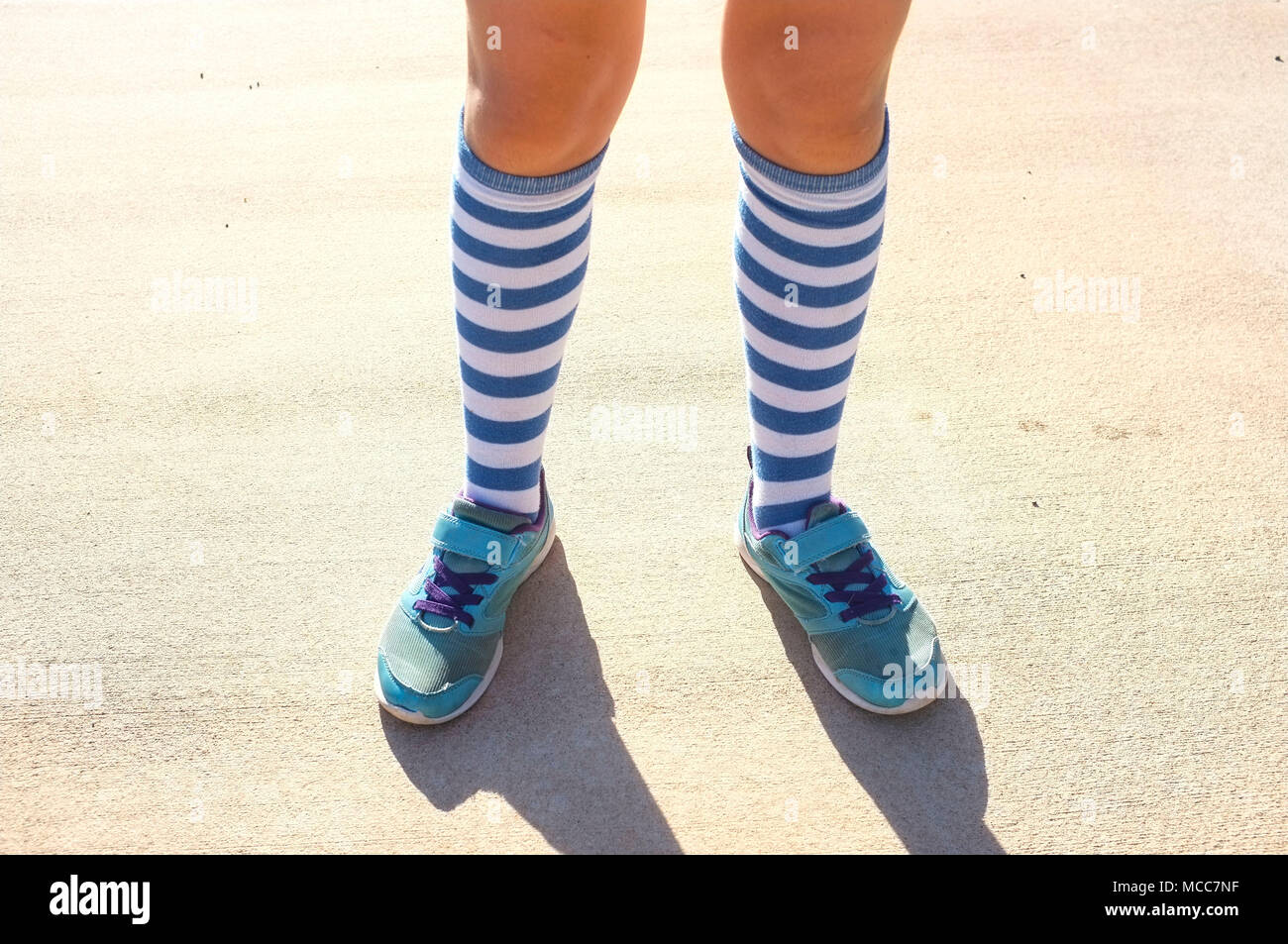 white girl's shoes and blue socks low section Stock Photo - Alamy