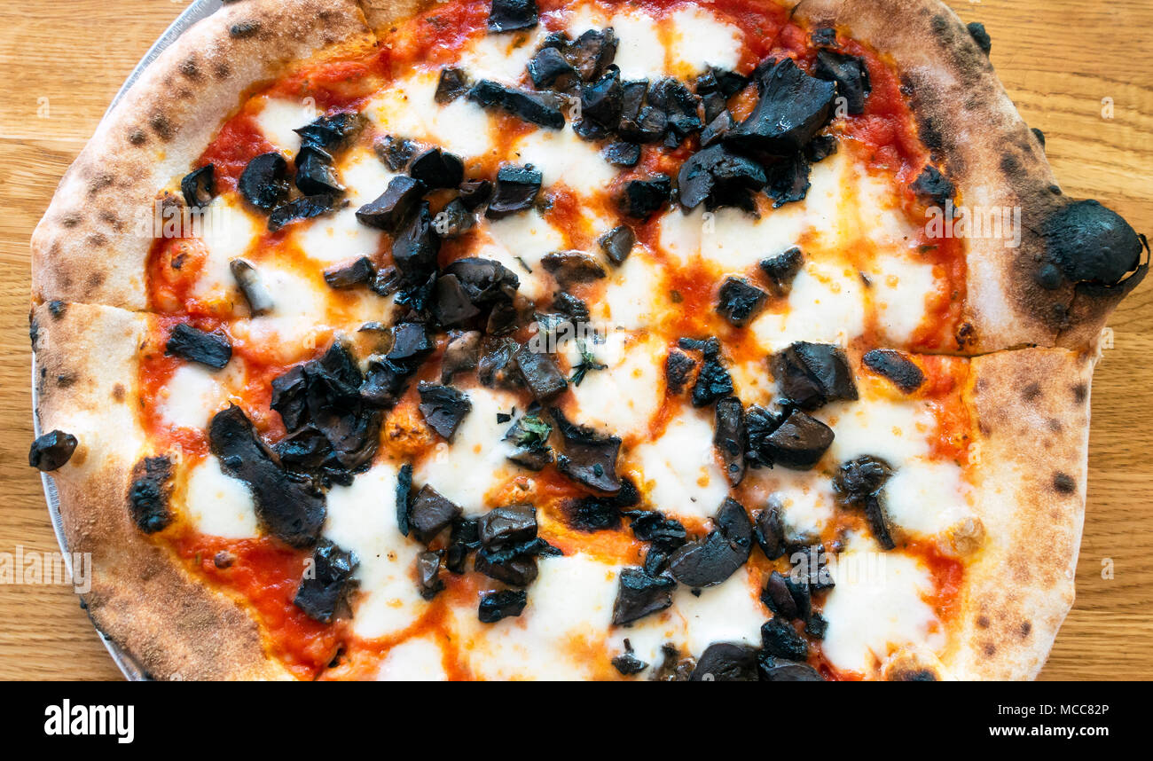 A mushroom pizza with fresh black mushrooms Stock Photo - Alamy