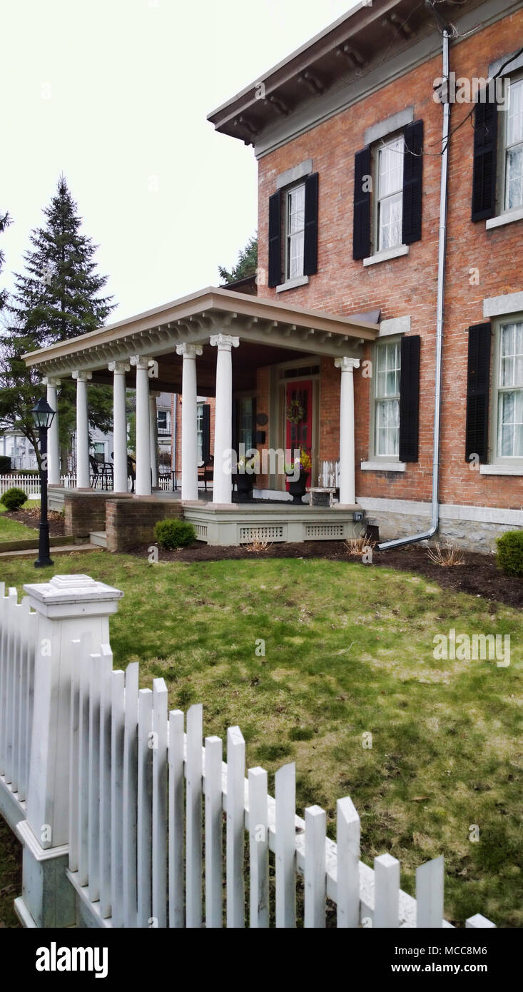 Beautiful brick home with white picket fence Stock Photo