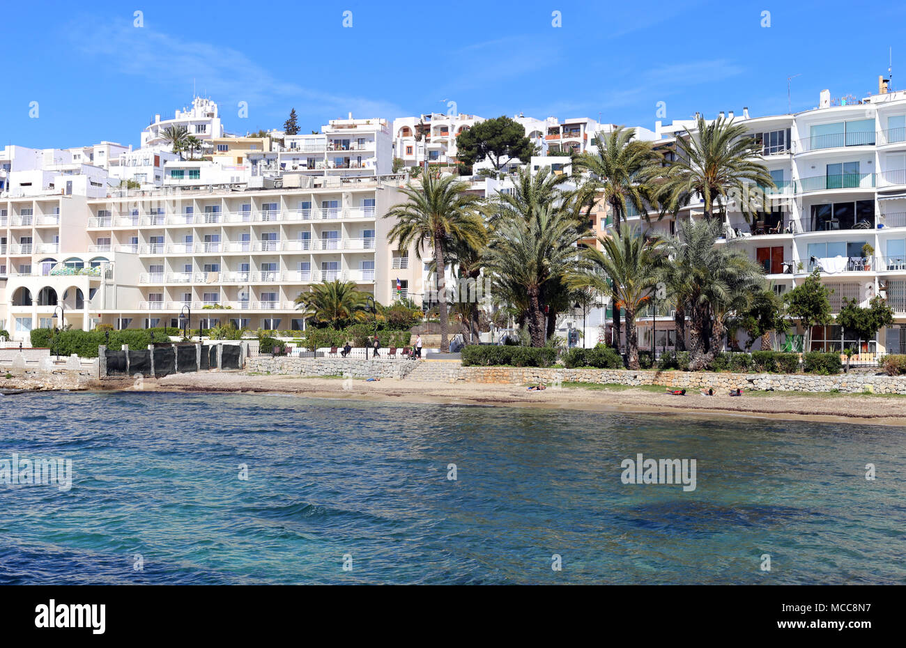 Beautiful sea view from the Island of Ibiza, Spain, Europe. Blue sky, sunlight, gorgeous turquoise sea and some plants and white buildings - amazing! Stock Photo