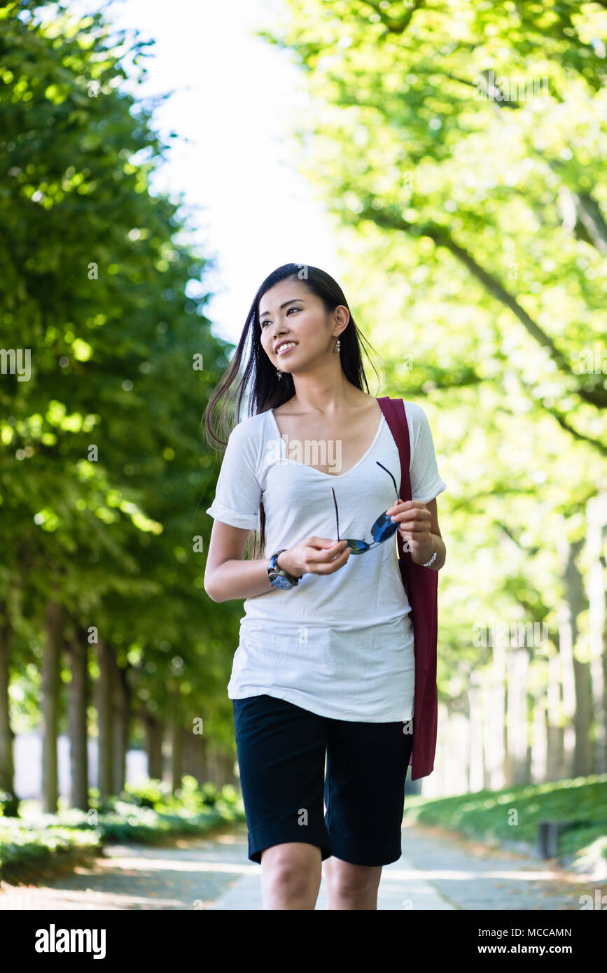 Attractive asian woman walking hi-res stock photography and images - Alamy