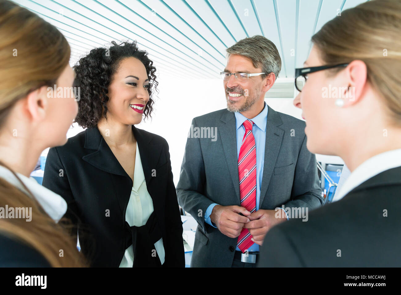 Co-workers having a conversation at the office Stock Photo