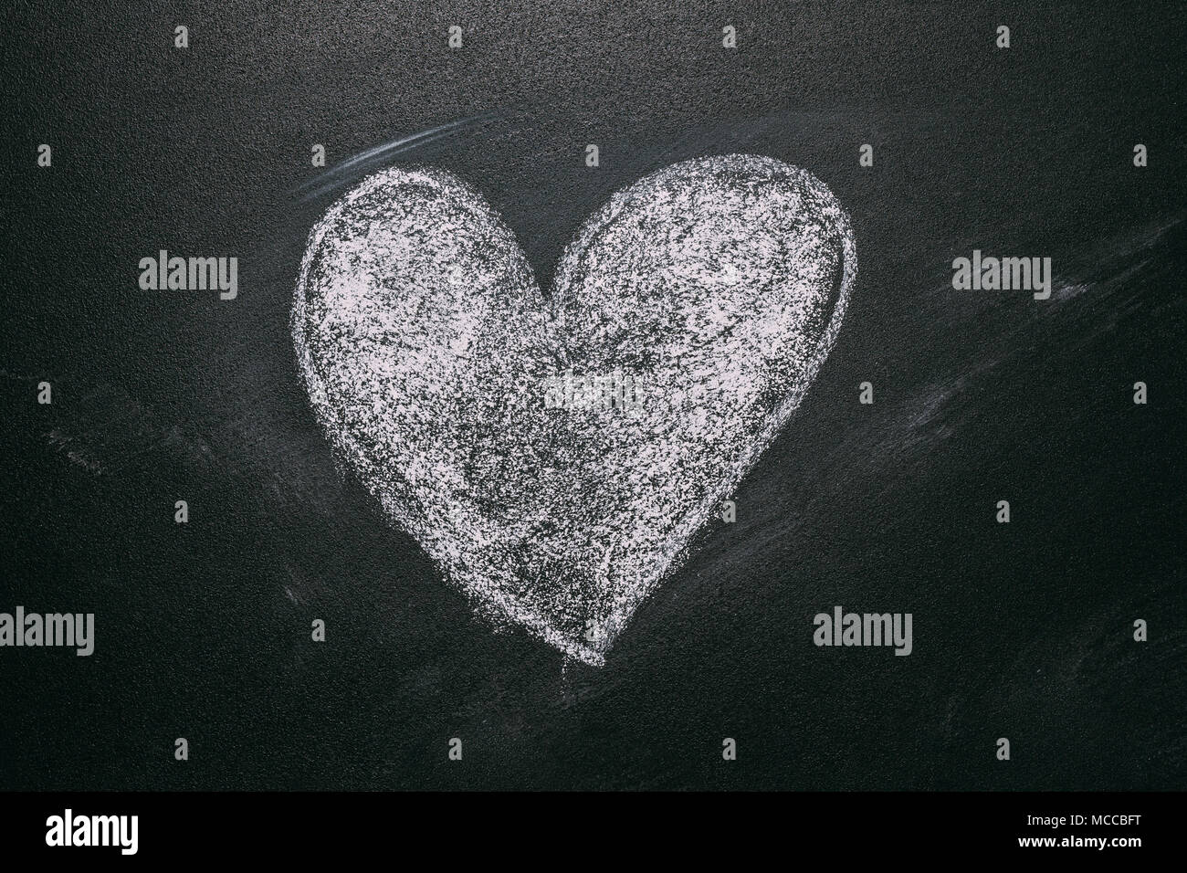 Love Heart Drawing On A School Chalkboard. Handwritten Message On A School Chalkboard Drawing With An Illustrated Heart Used As A Symbol, Concept Of L Stock Photo